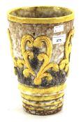 An Italian pottery cylindrical relief-moulded vase.