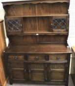 A 20th century dark stained dresser.
