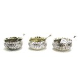 Three Victorian silver small condiment bowls and spoons.