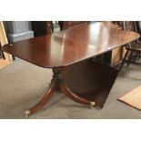 A mahogany veneer extendable dining table.