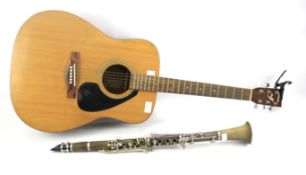 A Yamaha F-310 acoustic guitar and a clarinet.