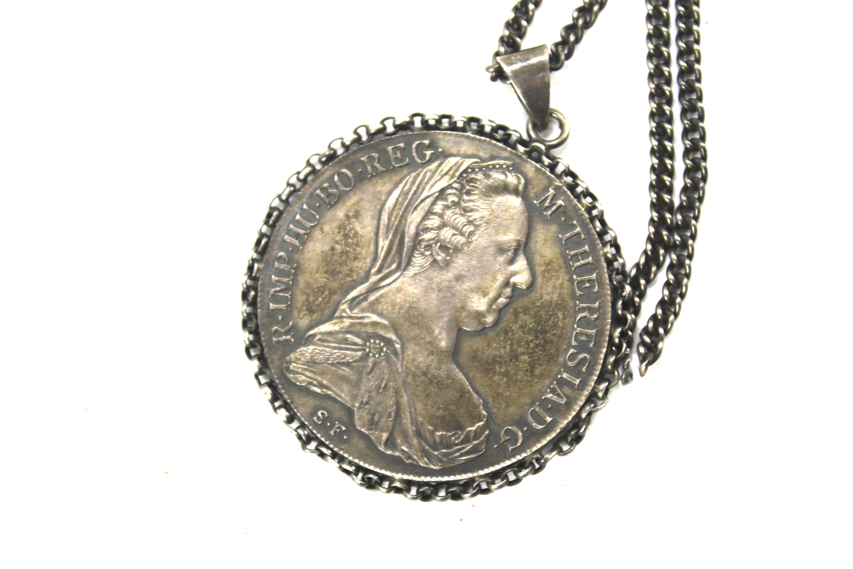 An Austrian Maria Theresa Thaler coin adapted into a white metal pendant. - Image 2 of 2