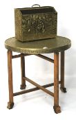 A small Indian brass top table and a magazine rack.