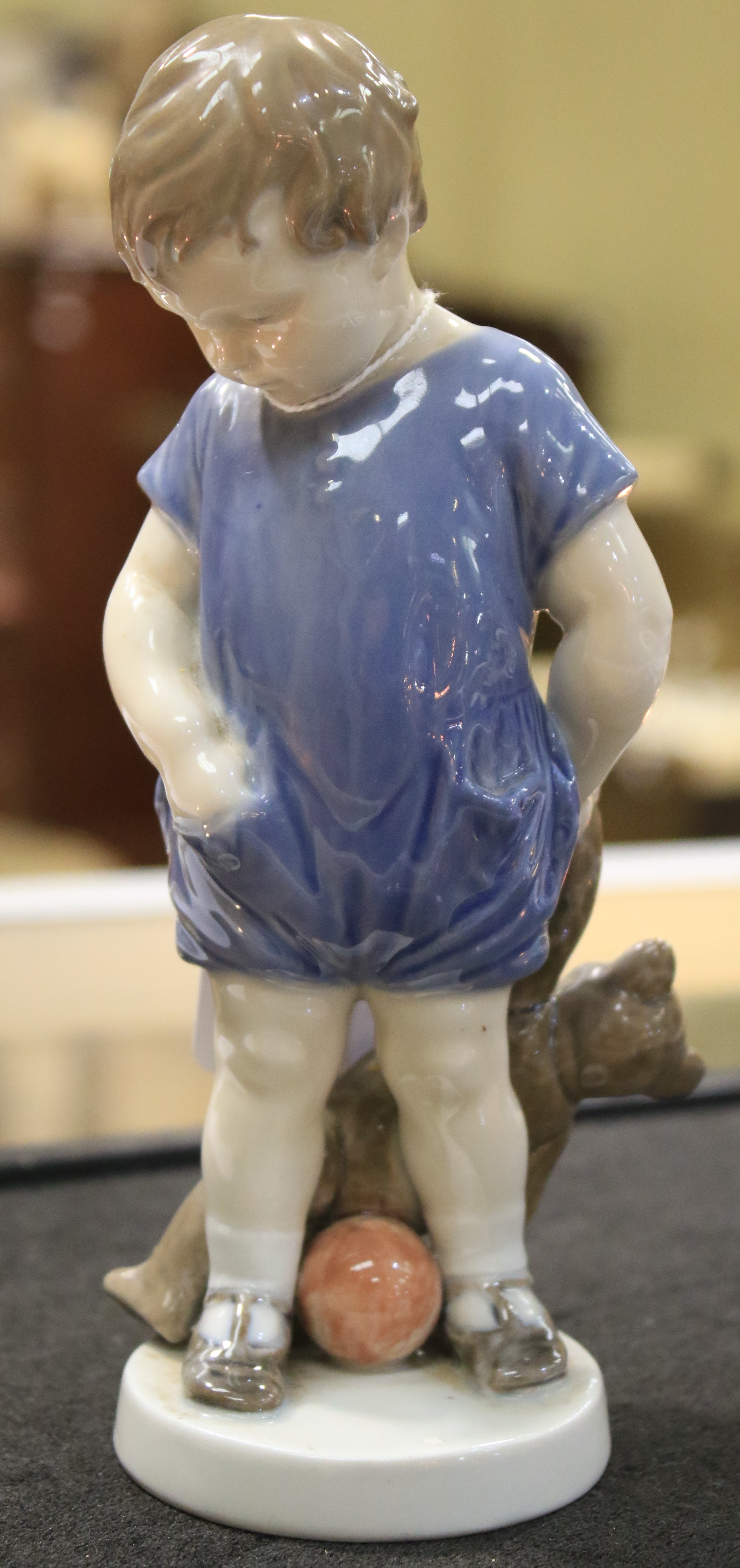 A Royal Copenhagen porcelain figure of a child holding a teddy bear. - Image 2 of 6