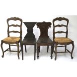 Two Georgian style oak hall chairs and two French 18th century style rush dining chairs.