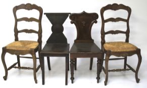 Two Georgian style oak hall chairs and two French 18th century style rush dining chairs.