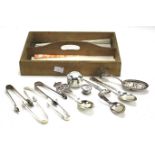 Assorted silver flatware, sugar tongs and other items.