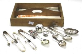 Assorted silver flatware, sugar tongs and other items.