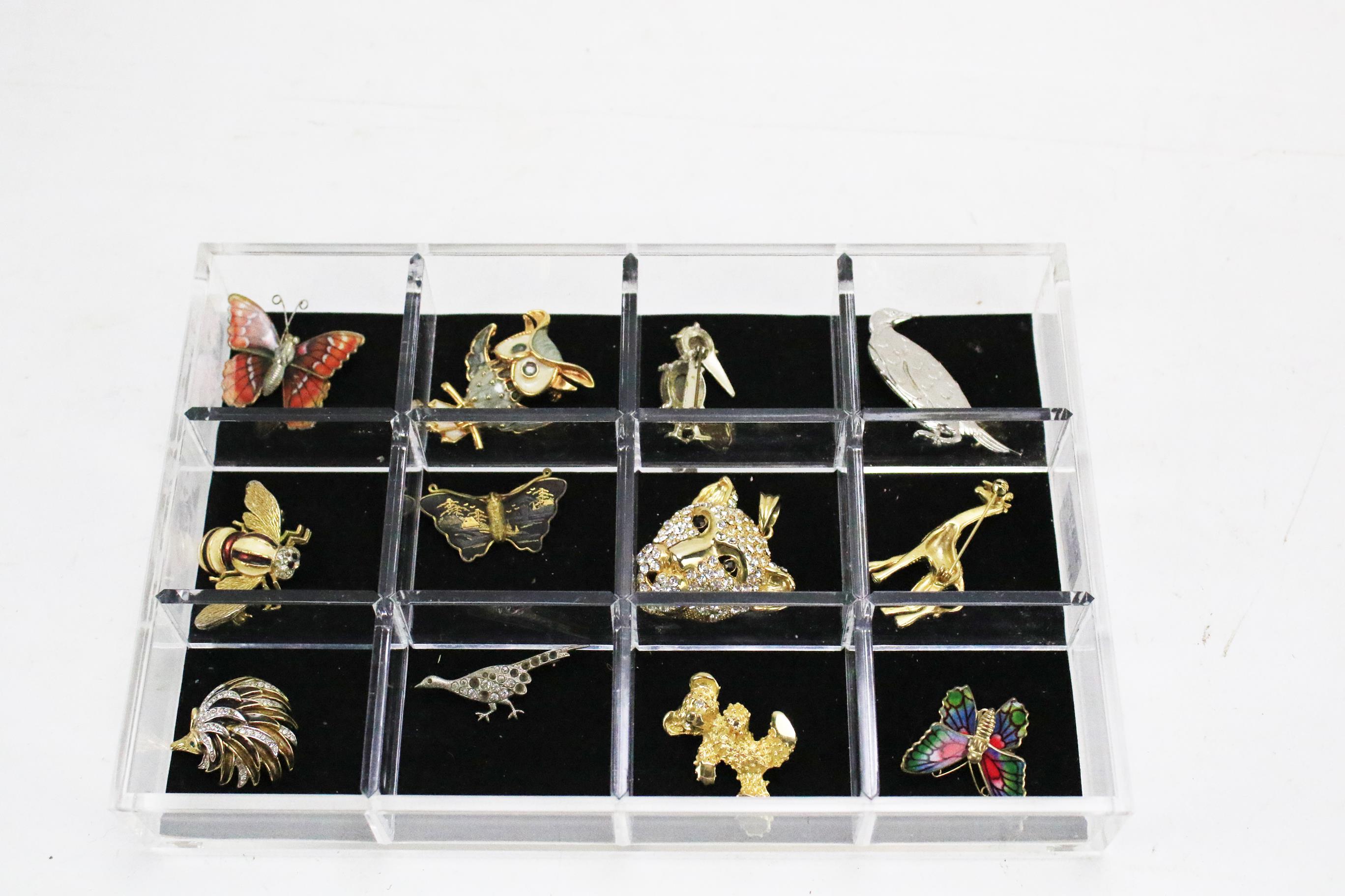 A group of twelve modern enamel and gilt metal animal brooches.