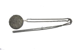 An Austrian Maria Theresa Thaler coin adapted into a white metal pendant.