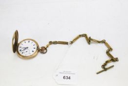 A gold plated open half hunter pocket watch and an Albert chain.