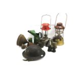 A World War II period military Brodie style helmet, two oil lamps and other items.