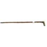 An antique walking cane with a horn handle.