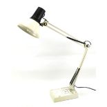 An anglepoise table lamp. In cream with a rectangular base.