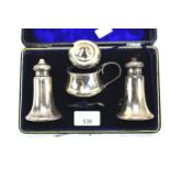 A Victorian silver cased condiment set.