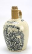 An 'Auld Long Syne' pottery bottle with wooden stopper.