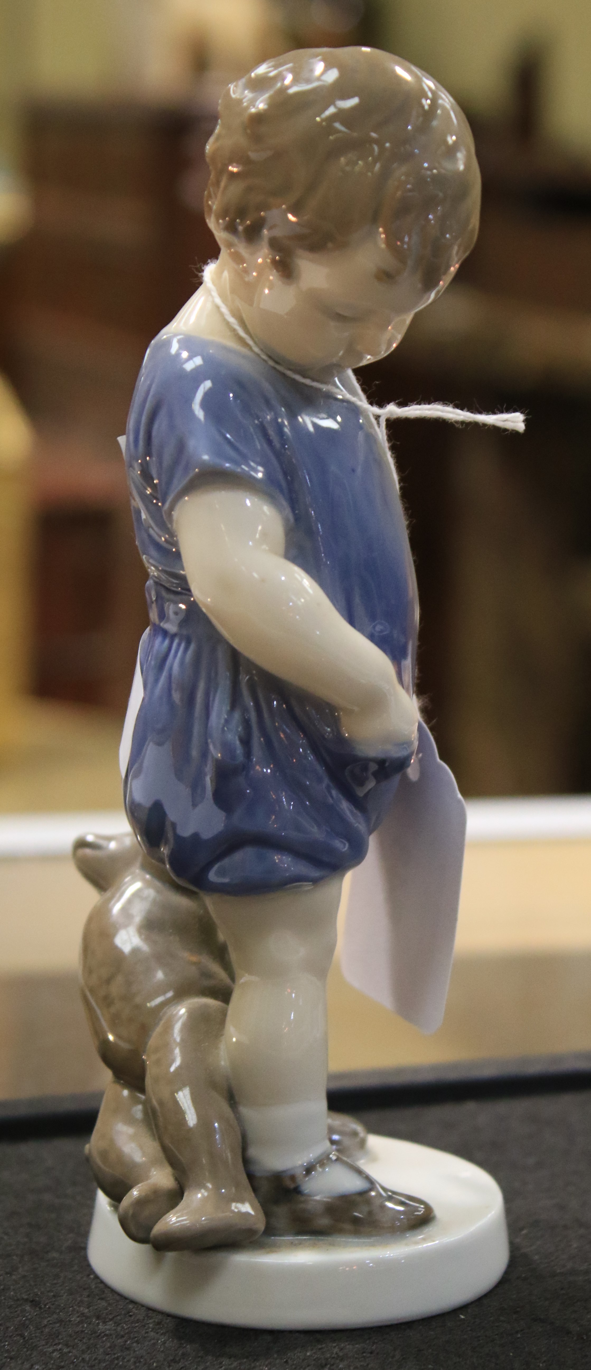 A Royal Copenhagen porcelain figure of a child holding a teddy bear. - Image 5 of 6