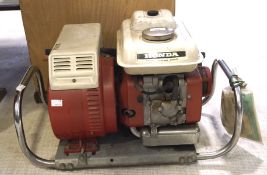A Honda petrol generator, model E800, with the original instruction manual.