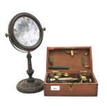 A early 20th century miniature microscope and a circular swing mirror.