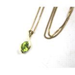 A 9ct gold pendant and chain. The pendant set with a green stone. Combined weight 3.