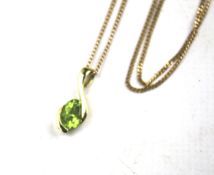 A 9ct gold pendant and chain. The pendant set with a green stone. Combined weight 3.