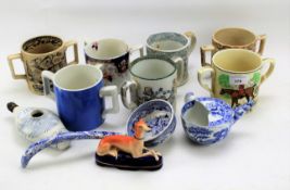 A collection of Staffordshire pottery loving cups and other items.