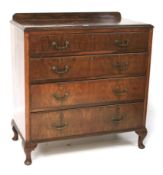 A mahogany veneered chest of drawers.