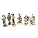 Four German porcelain figures and a pair of figural bookends.