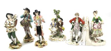 Four German porcelain figures and a pair of figural bookends.