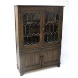 A stained oak glazed bookcase.