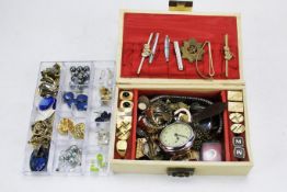 A jewellery box containing an assorted collection of cufflinks, tie clips, watches,