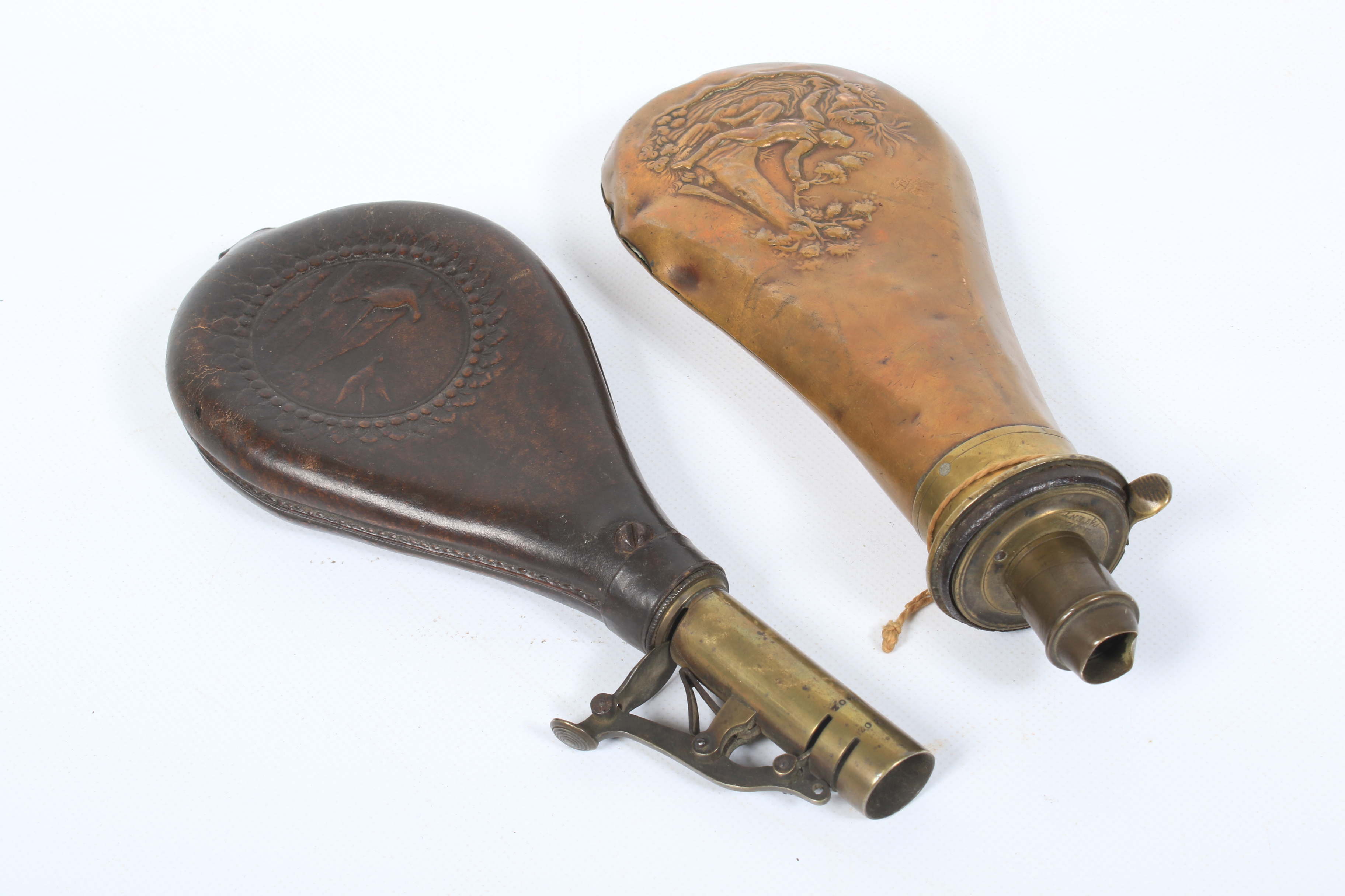 A brass powder flask and a leather shot flask.