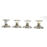 A set of four continental 800 grade silver squat candlesticks. Each measuring approximately 4.