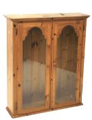 A 20th century pine display cabinet by Ducal.