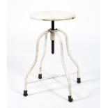 An industrial white painted metal stool.
