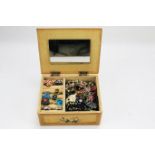 A collection of assorted costume jewellery in a wooden vintage jewellery box.