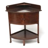 A mahogany corner wash stand. Of curved form, the lower section with a double door cupboard, L53.