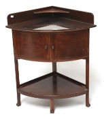 A mahogany corner wash stand. Of curved form, the lower section with a double door cupboard, L53.