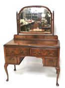 A 20th century mahogany dressing table and a chest of drawers.