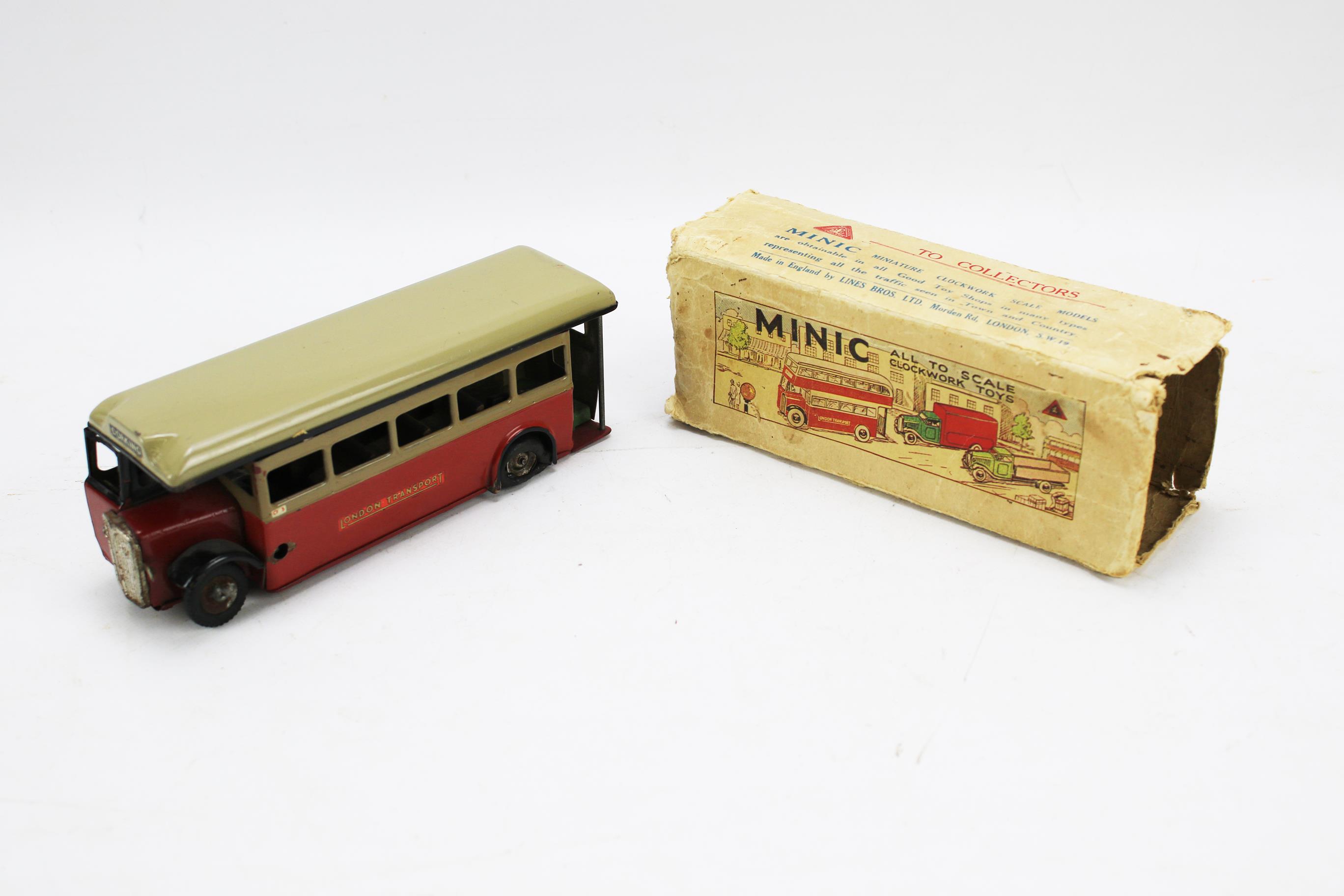 A mid-century Tri-ang minic clockwork scale model bus with original box. 18.