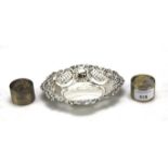 A pair of silver engine turned napkin ring and a pierced shaped oval dish.