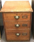 A mid century oak three drawer filing cabinet.