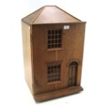 A vintage wooden dolls house with contents.