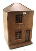 A vintage wooden dolls house with contents.