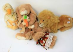 A group of four vintage soft toys.