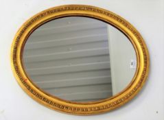 An ornate gilt framed wall mirror.