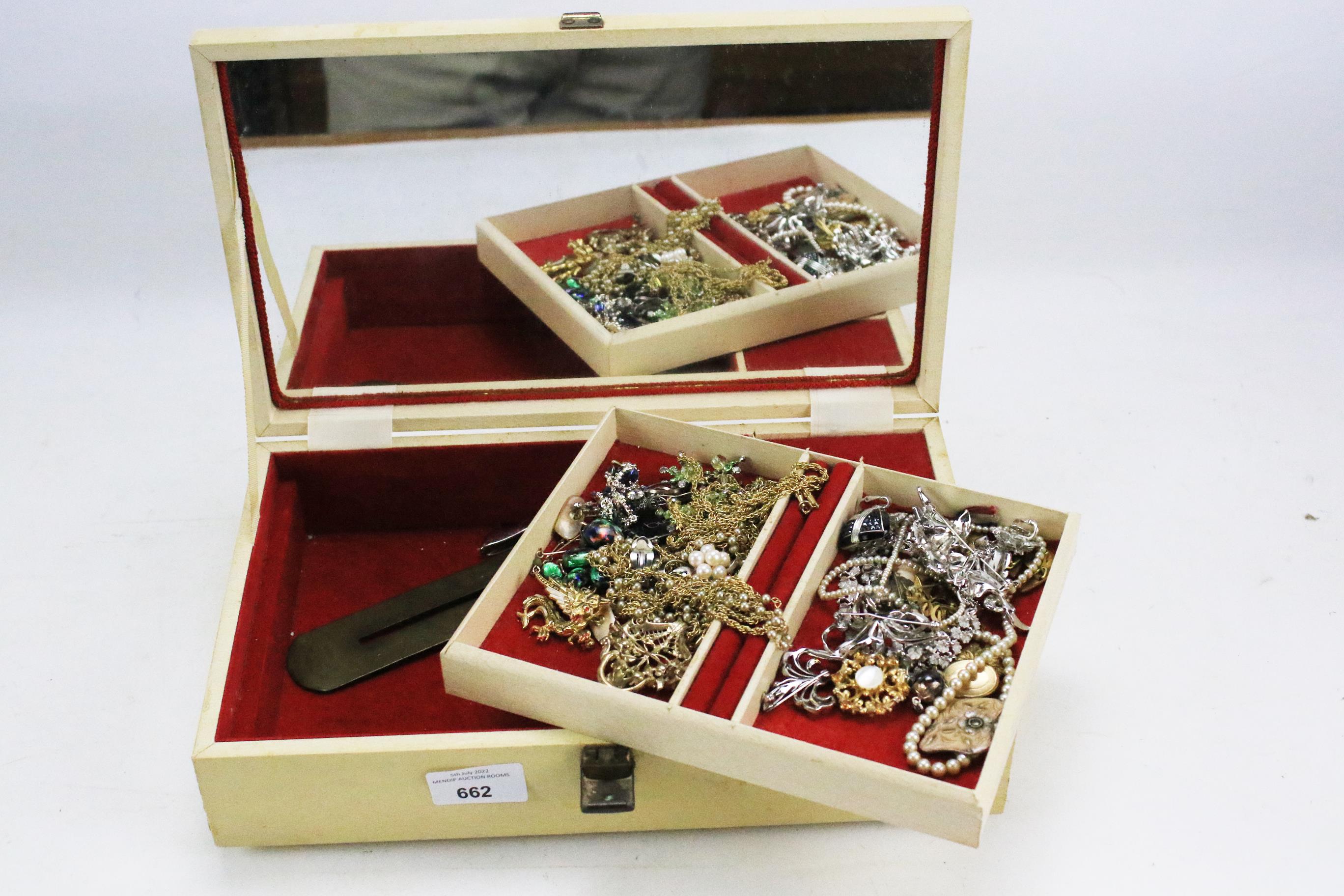 A collection of costume jewellery in a vintage jewellery box.