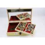 A collection of costume jewellery in a vintage jewellery box.