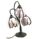 A contemporary table lamp in the form of three coloured glass flowers.