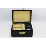 A black leather jewellery box with pull out compartment and combination lock